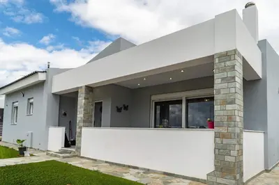a white house with a white wall at Casa Anavyssos in Anavissos
