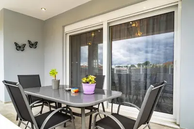 a dining room with a table and chairs and a window at Casa Anavyssos in Anavissos