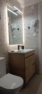 a bathroom with a sink and a toilet and a mirror at M20 Athens Apartments in Athens
