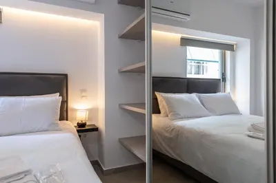 a bedroom with two beds and a mirror at M20 Athens Apartments in Athens