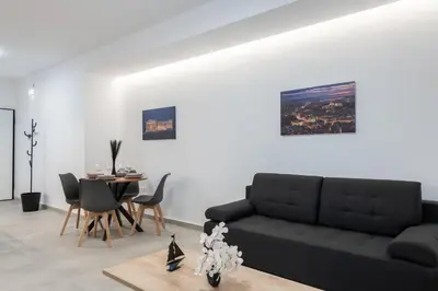 a living room with a black couch and a table at M20 Athens Apartments in Athens