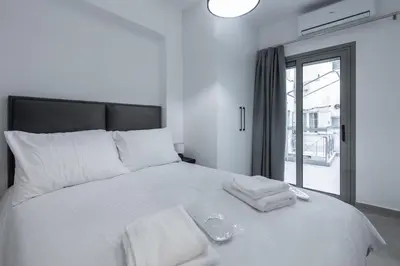 a bedroom with a white bed with towels on it at M20 Athens Apartments in Athens