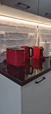 a counter with two pots and a suitcase on it at M20 Athens Apartments in Athens