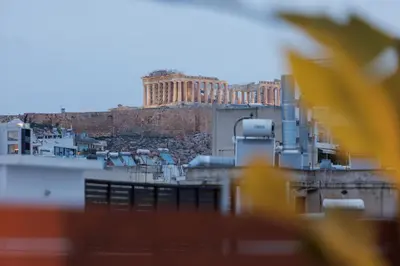 a view of the acropolis from the city of athens at Elysium Heated Jacuzzi with Acropolis View in Athens