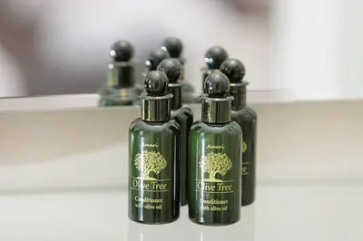a group of four bottles of olive tree hair products at Elysium Heated Jacuzzi with Acropolis View in Athens