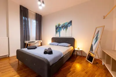 a bedroom with a bed with two shoes on it at HeKo Collection Athens Center 1 in Athens