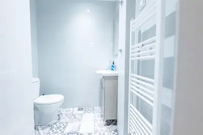 a white bathroom with a toilet and a sink at HeKo Collection Athens Center 1 in Athens