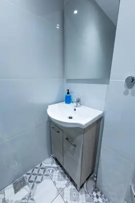 a white bathroom with a sink and a mirror at HeKo Collection Athens Center 1 in Athens