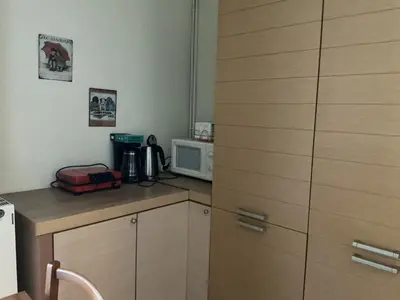 a small kitchen with a microwave and a counter top at Eleni's apartment in Piraeus