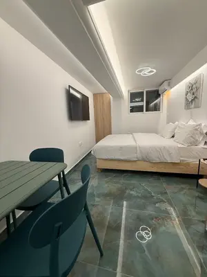 a bedroom with a bed and a table and chairs at City Center Green Lux Studio in Athens