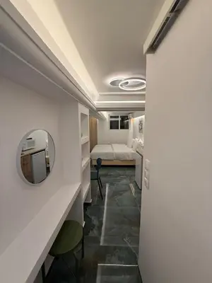 a hotel room with a bed and a mirror at City Center Green Lux Studio in Athens