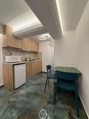 a kitchen with a table and chairs in a room at City Center Green Lux Studio in Athens