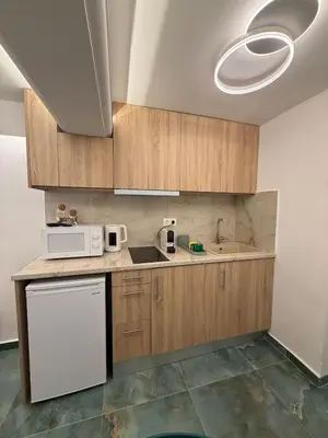 a kitchen with a sink and a microwave at City Center Green Lux Studio in Athens