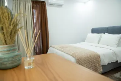 a bedroom with a bed and a table with a vase on it at Klitiou 7 Boutique Hotel in Athens