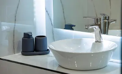 a bathroom with a sink and a faucet at Klitiou 7 Boutique Hotel in Athens