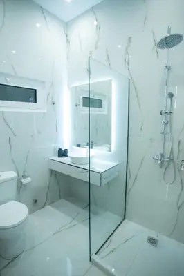 a white bathroom with a toilet and a sink at Klitiou 7 Boutique Hotel in Athens