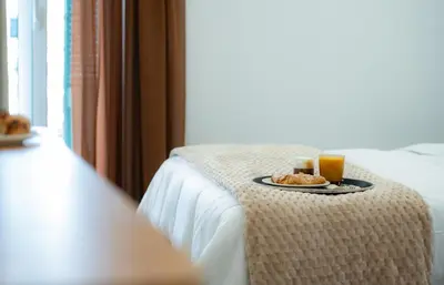 a table with a plate of food and two drinks at Klitiou 7 Boutique Hotel in Athens