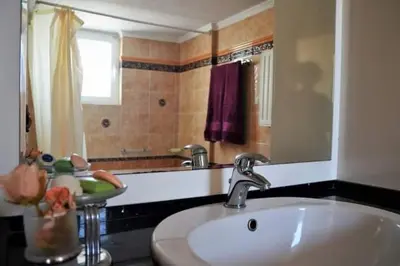 a bathroom with a sink and a mirror at Triple Nest Maisonette - Korydallos by ΜΡS in Piraeus