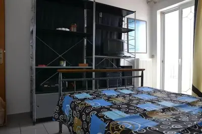 a bedroom with a bed with a blanket on it at Triple Nest Maisonette - Korydallos by ΜΡS in Piraeus