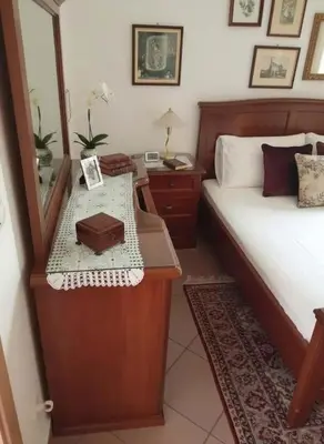 a bedroom with a bed with a mirror and a table at Triple Nest Maisonette - Korydallos by ΜΡS in Piraeus