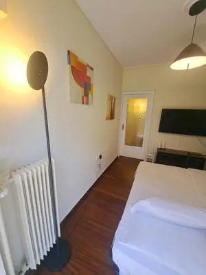 a bedroom with a bed and a flat screen tv at Retro Modern Apartment Pagrati in Athens