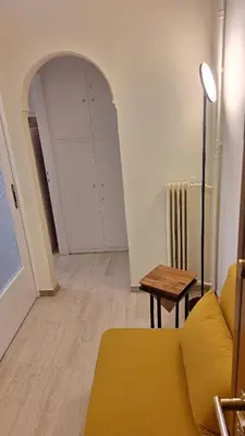a living room with a couch and a table at Retro Modern Apartment Pagrati in Athens
