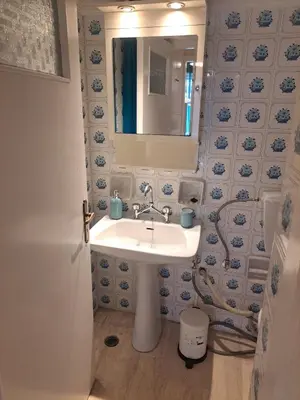 a bathroom with a sink and a mirror at Retro Modern Apartment Pagrati in Athens