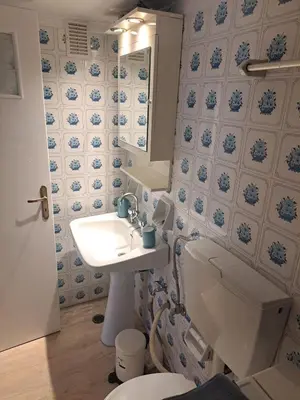 a bathroom with a toilet and a sink and a mirror at Retro Modern Apartment Pagrati in Athens
