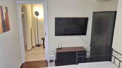 a bedroom with a bed and a television on the wall at Retro Modern Apartment Pagrati in Athens