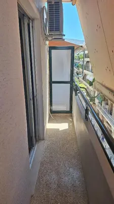 an empty hallway with a door in a building at Retro Modern Apartment Pagrati in Athens