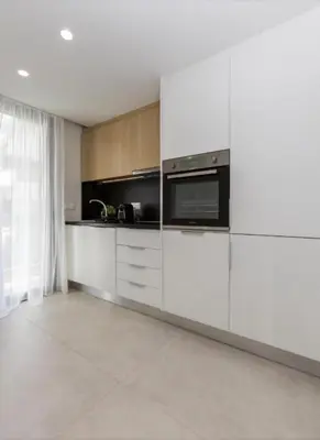 a kitchen with white cabinets and a microwave at Aqua Vista Varkiza, Pool & Private in Vari