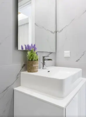 a white bathroom with a sink and a mirror at Aqua Vista Varkiza, Pool & Private in Vari