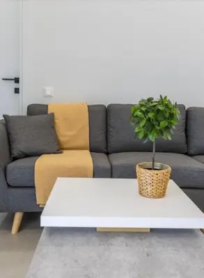 a white coffee table in a living room with a couch at Aqua Vista Varkiza, Pool & Private in Vari