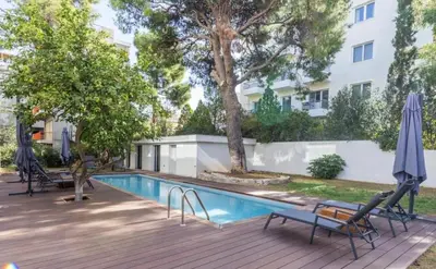a swimming pool with two chairs and an umbrella at Aqua Vista Varkiza, Pool & Private in Vari