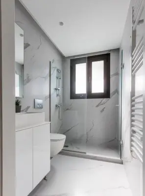 a white bathroom with a shower and a toilet at Aqua Vista Varkiza, Pool & Private in Vari
