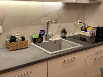 a kitchen counter with a sink and a microwave at Boutique stylish studio near Dafni Metro in Athens