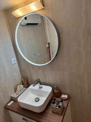 a bathroom with a white sink and a mirror at Boutique stylish studio near Dafni Metro in Athens