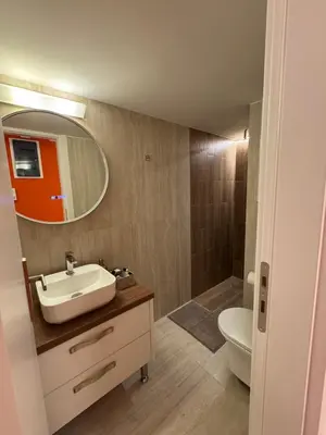 a bathroom with a sink and a toilet and a mirror at Boutique stylish studio near Dafni Metro in Athens