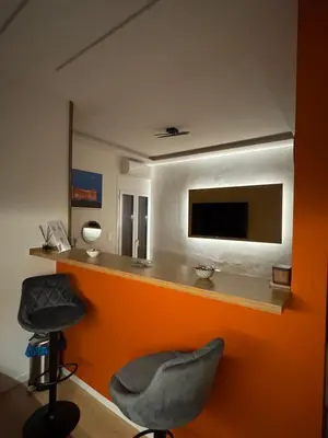 a room with a bar with a chair and a television at Boutique stylish studio near Dafni Metro in Athens