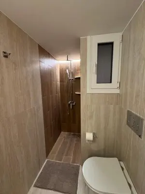 a bathroom with a toilet and a shower at Boutique stylish studio near Dafni Metro in Athens