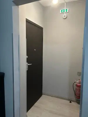 a hallway with a black door in a room at Stylish City Apartment in Athens
