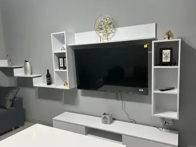 a living room with a flat screen tv on a wall at Stylish City Apartment in Athens