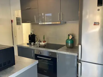 a kitchen with a refrigerator and a sink at Lagonisi Cottage - with spacious garden in Áyios Nikólaos