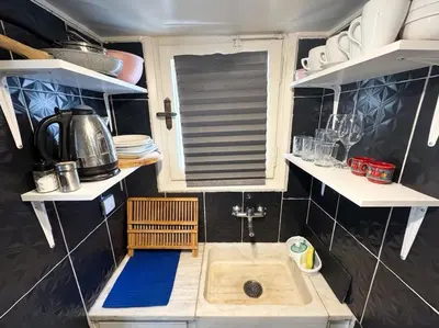 a small kitchen with a sink and a window at Roof top 5 steps from the beach in Athens