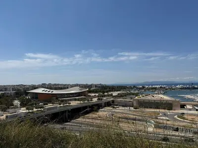 a view of a city with a building and the water at Roof top 5 steps from the beach in Athens