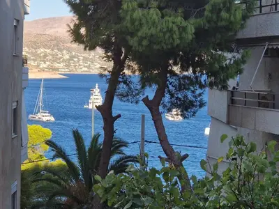 a view of the ocean with a boat in the water at The Varkiza Residence By the Sea in Vari