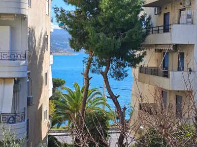 a view of the ocean from between two buildings at The Varkiza Residence By the Sea in Vari