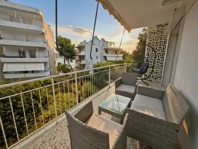 a balcony with chairs and a table on a balcony at The Varkiza Residence By the Sea in Vari
