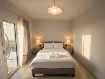 a bedroom with a bed and a large window at The Varkiza Residence By the Sea in Vari