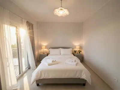 a bedroom with a bed with two towels on it at The Varkiza Residence By the Sea in Vari